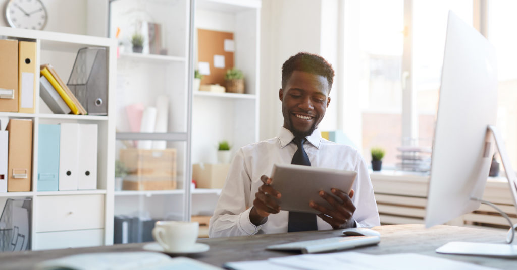 Young man in office setting enjoying the benefits of appraisal outsourcing